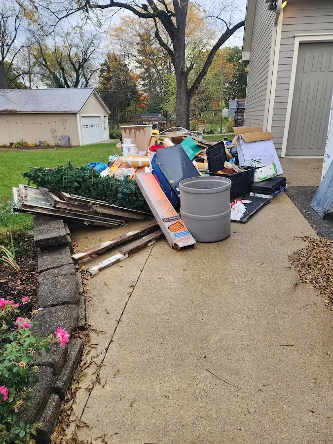 Dumpster being loaded with debris for Estate Cleanout Dumpster Rental in Shrewsbury